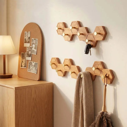 Cherry finish honeycomb wall hooks holding a coat and a scarf